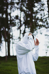 Rear view of woman standing on field