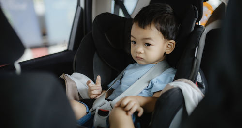 Close-up of baby boy sitting in car