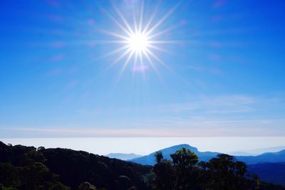 Scenic view of mountains against blue sky