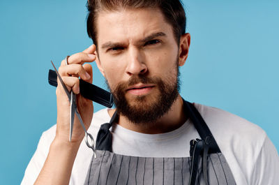 Portrait of young man holding camera