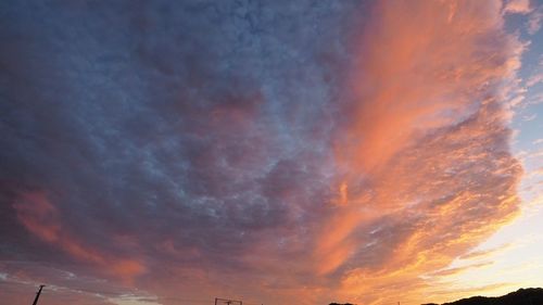 Low angle view of dramatic sky during sunset
