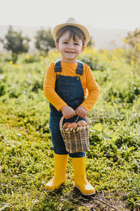 Portrait of young woman standing on field