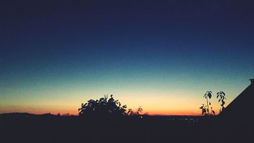 Scenic view of silhouette landscape against clear sky at sunset