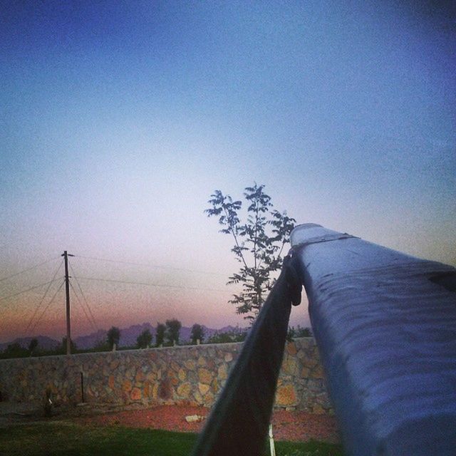 clear sky, landscape, copy space, tranquility, field, tranquil scene, tree, nature, blue, sky, scenics, beauty in nature, fence, horizon over land, rural scene, outdoors, dusk, non-urban scene, no people, silhouette