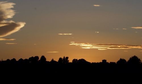 Silhouette trees against sky during sunset