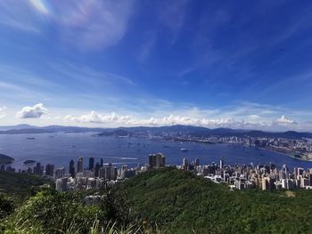 Scenic view of sea by city against sky