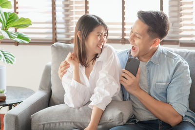 Young couple sitting on sofa