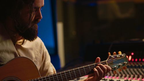 Close-up of man playing guitar