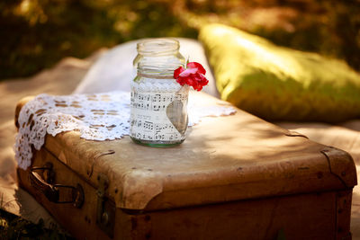 Sheet music in jar on suitcase