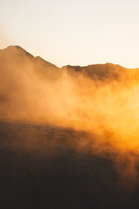 Scenic view of silhouette mountain against sky during sunset