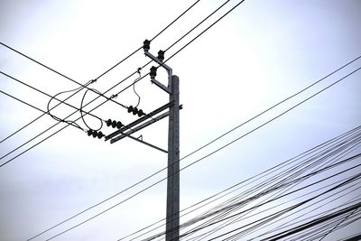 Low angle view of electricity pylon against sky