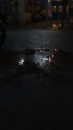 Wet street in city at night