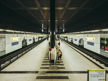 People waiting at railroad station platform