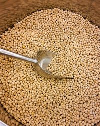 Close-up of chickpeas and a shovel