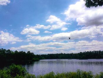 Scenic view of lake against cloudy sky