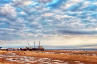 Sailboat on beach against sky