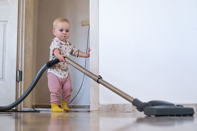 Portrait of cute boy playing with toy at home