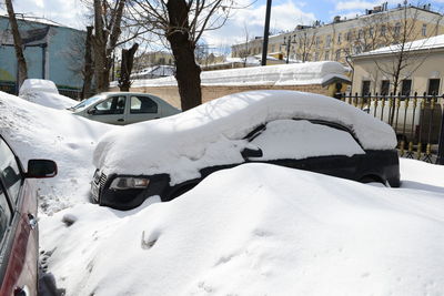 Snow covered car in city