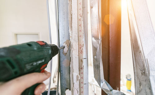 Close-up of hand holding glass window