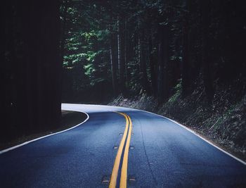 Empty road amidst trees