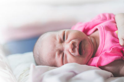 Close-up of baby sleeping on bed