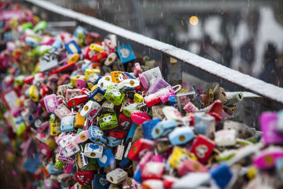 Colorful padlocks hanging in shop for sale during snowfall