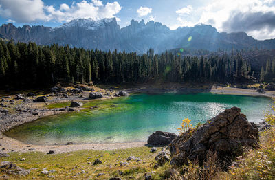 Lake carezza  lake with deep blue colored water and the dolomite mountain range in italy, europe.