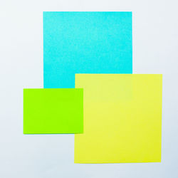 Close-up of yellow papers over white background