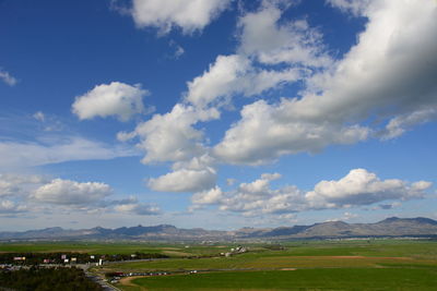 Scenic view of field against blue sky