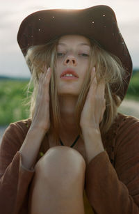 Portrait of young woman sitting outdoors