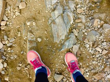 Low section of woman standing on rock