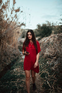 Portrait of young woman standing on land