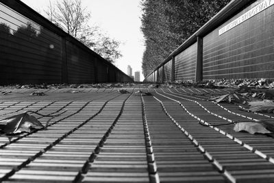Surface level of railroad tracks by buildings against sky