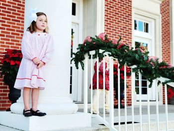 Portrait of child standing against building