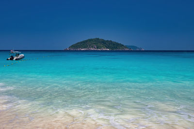 Scenic view of sea against clear blue sky