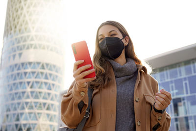 Portrait of young woman using mobile phone