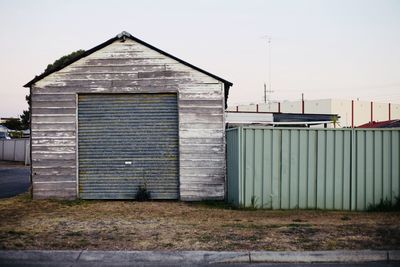 Closed door of building against sky