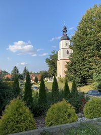 Panoramic view of trees and building against sky