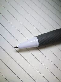 High angle view of pen on paper