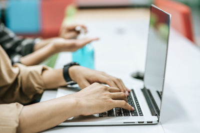 Midsection of man using laptop