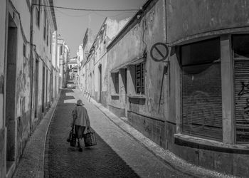 Rear view of people on street in city