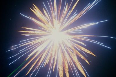 Low angle view of firework display against sky at night