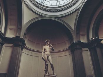 Low angle view of statue against historic building