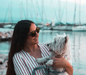 Portrait of woman with dog in water