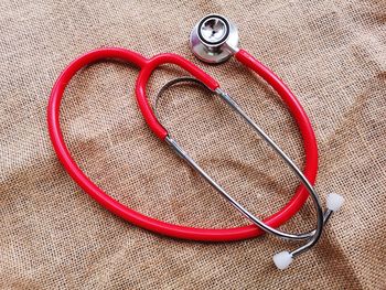 High angle view of stethoscope on burlap