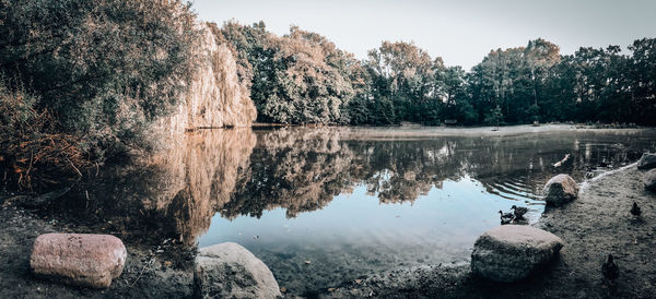 Reflection of trees in lake against sky