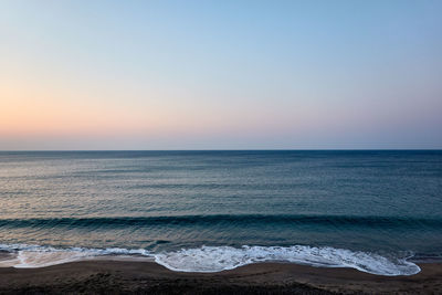 Scenic view of sea against clear sky during sunset