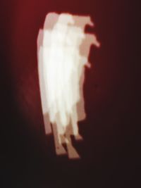 Close-up of illuminated lighting equipment against black background