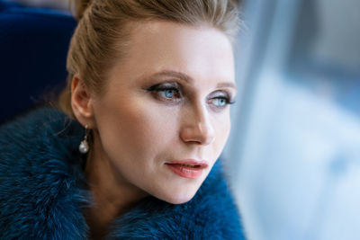 Beautiful woman rides in the train looks out the window