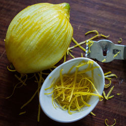 High angle close-up of lemon on wooden table